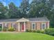 Charming brick home featuring a well-manicured lawn and a welcoming red front door at 365 Norcross St, Roswell, GA 30075