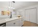 Bright kitchen featuring a farmhouse sink, marble counters, and modern pendant lighting at 365 Norcross St, Roswell, GA 30075