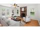 Inviting living room with a brick fireplace, hardwood floors, and french doors to the backyard at 365 Norcross St, Roswell, GA 30075