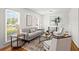 Bright and airy living room with stylish furnishings, hardwood floors and great natural light at 365 Norcross St, Roswell, GA 30075