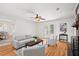 Bright living room with a fireplace, hardwood floors, and french doors leading outside at 365 Norcross St, Roswell, GA 30075
