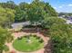 Aerial view of outdoor seating area surrounded by lush landscaping and a walking path at 365 Norcross St, Roswell, GA 30075