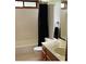 Classic bathroom featuring white tile, a tub with shower, vanity with sink, and toilet at 390 Hunt River Way, Suwanee, GA 30024