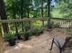 Inviting wooden deck featuring potted plants and views of the lush surrounding greenery at 390 Hunt River Way, Suwanee, GA 30024