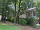 Suburban home with stone accents and mature trees in a lush setting at 390 Hunt River Way, Suwanee, GA 30024