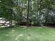 Suburban home with large trees and a sprawling green lawn at 390 Hunt River Way, Suwanee, GA 30024