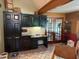 Eat-in kitchen featuring built-in desk, tile flooring, and ample storage space at 390 Hunt River Way, Suwanee, GA 30024