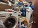 Functional laundry room with a washer, dryer, sink, and ample storage shelving at 390 Hunt River Way, Suwanee, GA 30024
