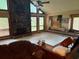 Spacious living room with stone fireplace and ample windows at 390 Hunt River Way, Suwanee, GA 30024