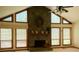 Living room with stone fireplace, vaulted ceilings, and natural light at 390 Hunt River Way, Suwanee, GA 30024