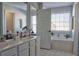 Bathroom featuring double sinks, a garden tub, large windows, and tiled floors at 401 Iona Abbey Ct # 6, Smyrna, GA 30082