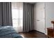 Simple bedroom with grey drapes, hardwood floors and closet at 401 Iona Abbey Ct # 6, Smyrna, GA 30082