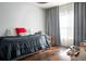 Comfortable bedroom with dark bedding, wood floors, and natural light at 401 Iona Abbey Ct # 6, Smyrna, GA 30082