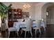 Chandelier illuminated dining area with hardwood floors and white seating at 401 Iona Abbey Ct # 6, Smyrna, GA 30082