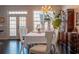 Bright dining room with dark floors, a chandelier, and a white tablecloth on the table at 401 Iona Abbey Ct # 6, Smyrna, GA 30082