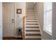 Entryway with a hardwood staircase, tiled floors, and a coat closet near the front door at 401 Iona Abbey Ct # 6, Smyrna, GA 30082