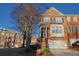 Charming brick townhome featuring a manicured lawn, attached garage, and classic architectural details at 401 Iona Abbey Ct # 6, Smyrna, GA 30082