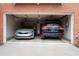 Garage featuring two parked vehicles, exposed ceiling, overhead door, and concrete floor at 401 Iona Abbey Ct # 6, Smyrna, GA 30082