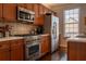 Modern kitchen features stainless steel appliances and cherry wood cabinets at 401 Iona Abbey Ct # 6, Smyrna, GA 30082