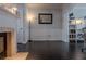 Bright living room featuring hardwood floors, wainscoting, and fireplace with mantle at 401 Iona Abbey Ct # 6, Smyrna, GA 30082