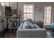 Living room featuring hardwood floors, a gray couch, large windows, and a work area at 401 Iona Abbey Ct # 6, Smyrna, GA 30082