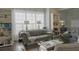 Comfortable living room showcasing a tufted couch, built-in bookshelves, and plenty of natural light at 401 Iona Abbey Ct # 6, Smyrna, GA 30082