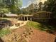 Scenic backyard featuring a fire pit area, lush greenery, and a charming single-Gathering home at 2062 Valiant Ne Dr, Atlanta, GA 30345