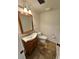 Traditional bathroom with a wood vanity, decorative mirror, and beadboard paneling to give it charm at 2062 Valiant Ne Dr, Atlanta, GA 30345