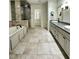 Spacious bathroom featuring tile floors, a large tub, and double vanity sinks with granite countertops at 2062 Valiant Ne Dr, Atlanta, GA 30345
