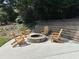 Outdoor fire pit area with stone surround and seating, set against a landscaped backdrop at 2062 Valiant Ne Dr, Atlanta, GA 30345