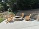 Outdoor stone fire pit area featuring comfortable Adirondack chairs and mature landscaping at 2062 Valiant Ne Dr, Atlanta, GA 30345