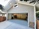 Spacious two-car garage with ample storage space, convenient side door, and durable siding for easy maintenance at 2062 Valiant Ne Dr, Atlanta, GA 30345