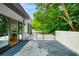 Expansive outdoor patio with slider to the living room and a tree at 23 Walthall Ne St, Atlanta, GA 30317