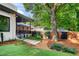 Lush backyard with a covered patio, manicured lawn, and thoughtful landscaping at 23 Walthall Ne St, Atlanta, GA 30317