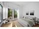 Bright bedroom with large windows and hardwood floors, featuring neutral decor and a comfortable aesthetic at 23 Walthall Ne St, Atlanta, GA 30317