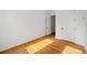 Sunlit room with hardwood floors, white walls, baseboard molding and two doors at 23 Walthall Ne St, Atlanta, GA 30317