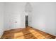 Spacious bedroom with hardwood floors, a double door closet, and a door to the walk-in closet at 23 Walthall Ne St, Atlanta, GA 30317