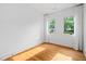 Bright, modern bedroom with hardwood floors, large windows, and white curtains at 23 Walthall Ne St, Atlanta, GA 30317