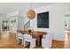 Dining room boasts hardwood floors, modern lighting, and statement artwork at 23 Walthall Ne St, Atlanta, GA 30317