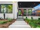 Charming exterior view with a covered patio, landscaped yard, and white brick steps at 23 Walthall Ne St, Atlanta, GA 30317