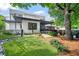 Beautiful exterior featuring a manicured lawn, mature trees, and a covered porch, creating an inviting outdoor space at 23 Walthall Ne St, Atlanta, GA 30317