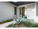 Charming front entry with bright, welcoming door, manicured landscaping, and modern accents at 23 Walthall Ne St, Atlanta, GA 30317