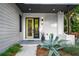 Inviting front entrance with a unique front door, tasteful landscaping, and stylish exterior lighting at 23 Walthall Ne St, Atlanta, GA 30317