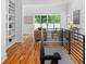 Bright upstairs hallway with wooden floors, built-in bookshelves, and living room view at 23 Walthall Ne St, Atlanta, GA 30317