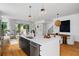 Bright, open-concept kitchen with stainless steel appliances, quartz countertop island and hardwood flooring at 23 Walthall Ne St, Atlanta, GA 30317