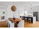 An open kitchen and dining area with island seating and modern pendant lighting at 23 Walthall Ne St, Atlanta, GA 30317