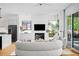 Bright living room features a fireplace, modern decor, and sliding glass doors to the outdoors at 23 Walthall Ne St, Atlanta, GA 30317
