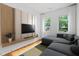 Modern living room featuring a stylish entertainment center and a comfortable sectional sofa at 23 Walthall Ne St, Atlanta, GA 30317