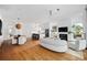 Open-concept living area with hardwood floors, fireplace, and seamless flow into kitchen and dining at 23 Walthall Ne St, Atlanta, GA 30317