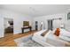 Large main bedroom featuring hardwood floors, a sliding barn door, and access to the living room at 23 Walthall Ne St, Atlanta, GA 30317